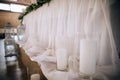 The table of the bride and groom is decorated with candles and candlesticks