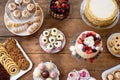 Table with cakes, cookies, cupcakes, tarts and cakepops.