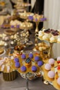 Table with cakes, sweets, candy, buffet. Dessert table for a party goodies for the wedding banquet area. Close up candy bar.