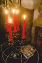 Table with candles and cards for fortune telling. Witch ritual concept.