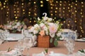 table centerpiece with white and peach rustic floral arrangement in wood box. Rustic wedding table.