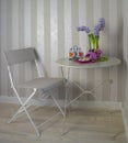 Table and chair in a cafe, summer interior with flowers and sweets