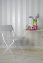 Table and chair in a cafe, summer interior with flowers and sweets