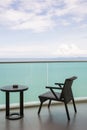 Table and chair with outdoor balcony and sea .The chair and table on balcony sea view. Chair with table set on balcony hotel room Royalty Free Stock Photo
