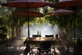 table and chair and red umbrella at patio with light ray through Royalty Free Stock Photo