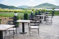 Table and chairs in the balcony of outdoor restaurant view nature farm and mountain background - dining table on the terrace Royalty Free Stock Photo