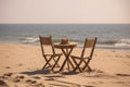 A table and chairs on the beach at sunset, created by Generative AI Royalty Free Stock Photo