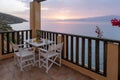 Table and chairs with breakfast during sunrise at the meditarian sea in Greece Royalty Free Stock Photo