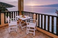 Table and chairs with breakfast during sunrise at the meditarian sea in Greece Royalty Free Stock Photo