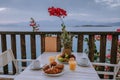 Table and chairs with breakfast during sunrise at the meditarian sea in Greece Royalty Free Stock Photo