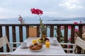 Table and chairs with breakfast during sunrise at the meditarian sea in Greece Royalty Free Stock Photo