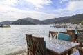 Table with chairs on gocek beach with mountains in Gocek