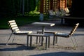 Table with chairs on a gravel surface as a part of a rest place in a city park construction metal seating areas are lined with Royalty Free Stock Photo