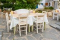 Table with chairs in Greek restaurant in Parikia town on Paros island. Cyclades. Greece Royalty Free Stock Photo