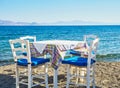 A table with chairs of a greek tavern. Kos, Greece. Royalty Free Stock Photo