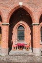 Table and chairs in a medieval arch