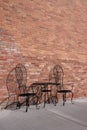 Table and chairs at an old brick storefront Royalty Free Stock Photo