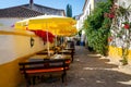 Table and chairs in open air street cafe or restaurant on narrow street of european town Royalty Free Stock Photo