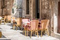 Table and chairs at the restaurant in narrow street are prepared for guests and tourist. Old city of Dubrovnik, Croatia Royalty Free Stock Photo