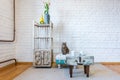 Table, chairs, shelves on the background of a white brick wall in vintage loft interior with cat Royalty Free Stock Photo