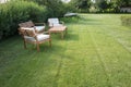 Table and chairs standing on a lawn at the garden, backyard. Outdoor garden furniture Royalty Free Stock Photo