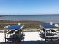 Table and chairs on the terrace of a restaurant on the beach Royalty Free Stock Photo