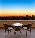 Table and chairs on a terrace, view on a city