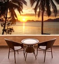 Table and chairs on a terrace, view on a tropical beach