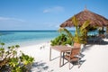 Table and chairs at tropical beach restaurant, Maldives Royalty Free Stock Photo