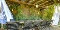 Table and chairs under a wooden pergola