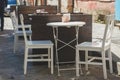 Table and chairs in white color in a summer street cafe Royalty Free Stock Photo