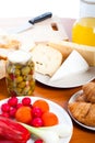 Table with cheese, olives, vegetable and knife