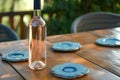 table with chilled wine bottle, blue ceramic coasters