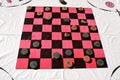 Table cloth with a checkerboard pattern and wood checkers