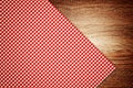 Table cloth, kitchen napkin on wooden background.