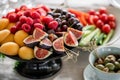 Table with cold snacks and tableware. Fresh Fruit platter on banquet table at business or wedding event venue. Raspberry Royalty Free Stock Photo