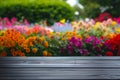 table with a colorful flowerbed as backdrop