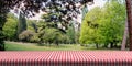 Table covered with red tablecloth on green park background, copy space. 3d illustration Royalty Free Stock Photo