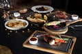 the table is covered with various meat dishes. delicious dishes are prepared for the celebration