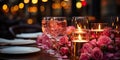 The table in a cozy restaurant, where candles in glass candlesticks and rose petals give a romanti Royalty Free Stock Photo