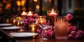 The table in a cozy restaurant, where candles in glass candlesticks and rose petals give a romanti Royalty Free Stock Photo