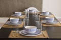 A table with crockery, plates, glasses and cutlery