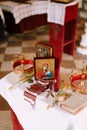 Table with crowns, candles, the icon of the Mother of God and the Bible in the Church of St. Sava in Tivat