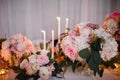 Table decor with white flowers and candles for a wedding party