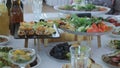 Table decorated for the holiday. Beautifully decorated banquet table with canapes and appetizers. Served table with food