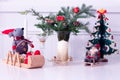 Table decorated for the Holidays with small wooden Christmas tree, plush mouse and Santa Claus on sleds Royalty Free Stock Photo