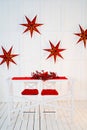 table is decorated for new year with red tablecloth, wreath and candles. Royalty Free Stock Photo