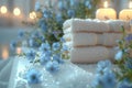 Table decorated with towels, blue flowers, and candles Royalty Free Stock Photo