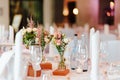 Table decoration with dishes flowers and candles in a bright wedding location