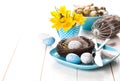 Table decoration with easter eggs nest on plate